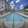 pool with reclining seats and lush landscaping