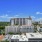 wide exterior view showing building, local community and some views of outdoor pool and courtyard