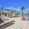 pool with reclining seats and lush landscaping