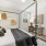bedroom with a large window and modern decor